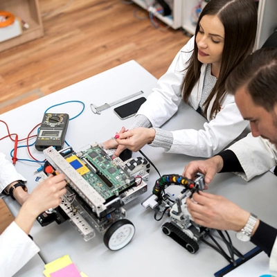 Hands-on electronics build and test on a bench.